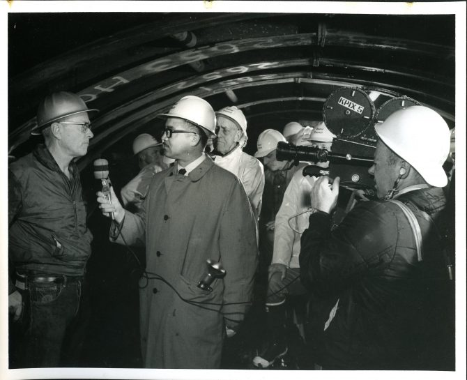 KPIX cameraman and Benjamin V. Williams interviewing men in hard hats