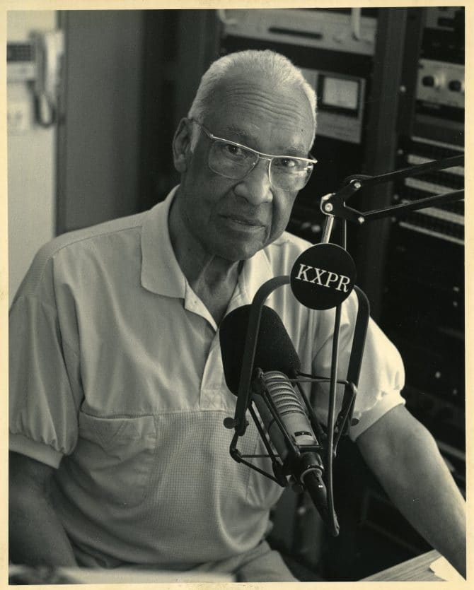 Phillip Jenkins sitting in radio studio in front of microphone [ 045 ] circa 1980s
