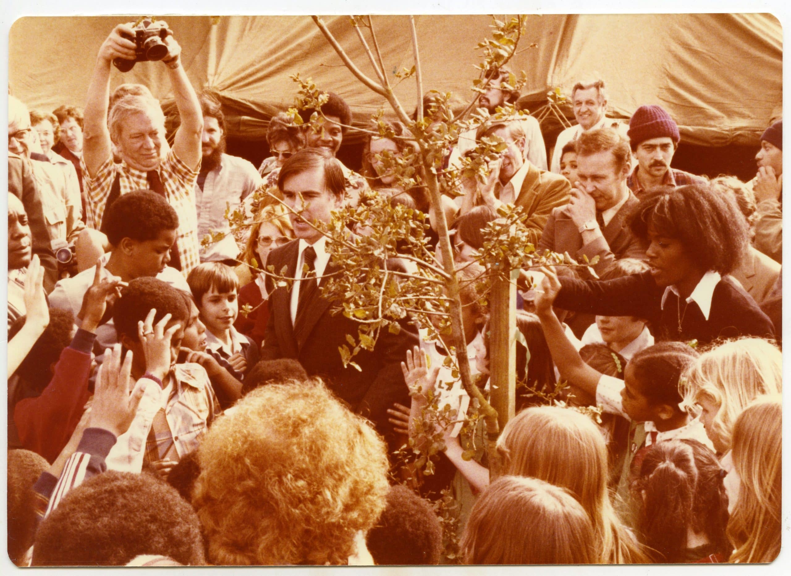 Historic image of California Governor Jerry Brown standing in crowd at Arbor Day tree planting at Joaquin Miller Park