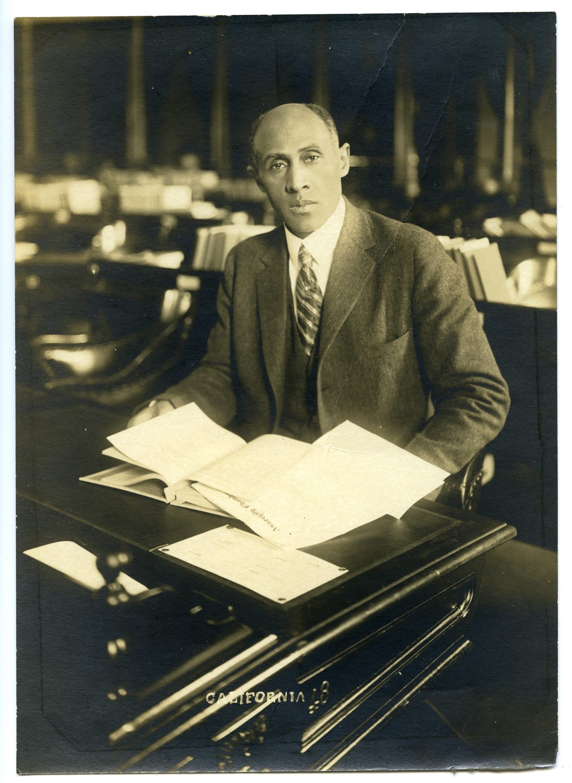 Frederick M. Roberts seated at his desk in the California State Legislature