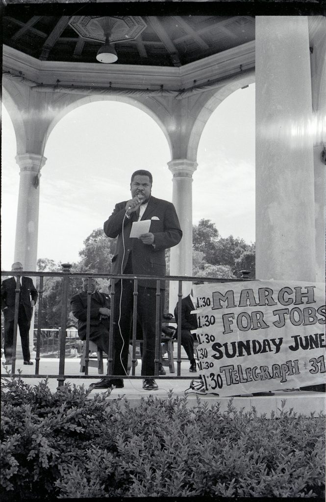 Rev. H. Hazaiah Williams giving speech at March for Jobs and BART protest at Lake Merritt gazebo