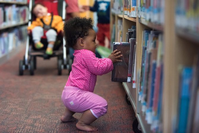 crouching toddler grabs kid's book out of stack
tags:
children, toddlers, baby, books