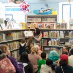 Drag Queen Story Time performer reads book at the Main Branch Children's Room