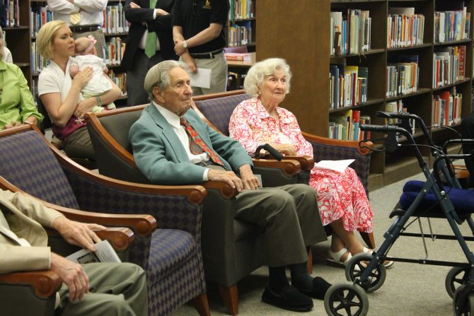 elderly people in chairs at library with wheeled walker nearby