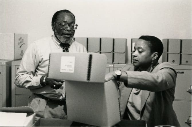 Staff of the Northern California Center for Afro-American History & Life examining archival box, circa 1990s, East Bay Negro Historical Society records, MS 32, African American Museum & Library at Oakland, Oakland Public Library.