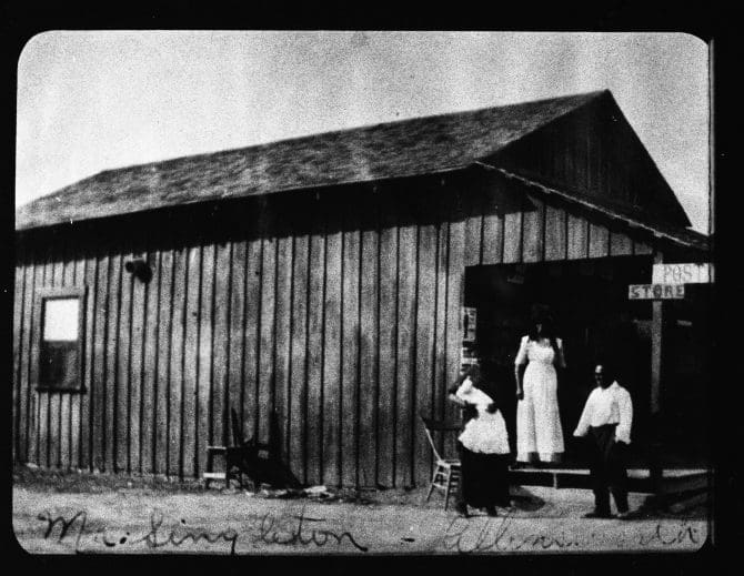 Historic image of Mr. Singleton and two women standing outside Allensworth store