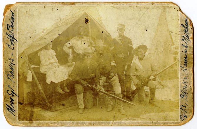 Group of soldiers and girl in front of tent in Yountville