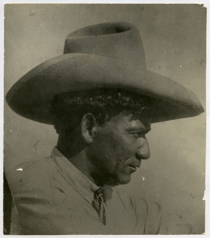 Jim Clark wearing western tie and cowboy hat