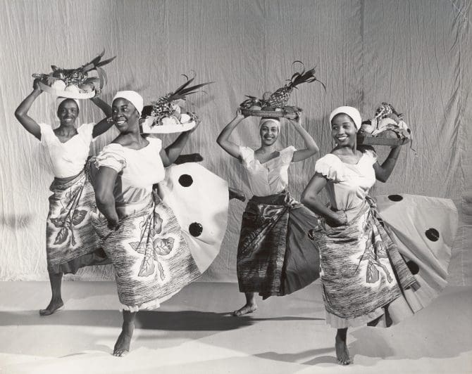 Ruth Beckford and three dancers in Haitian dress holding fruit trays