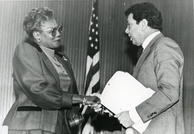 BART board of directors president Margaret Pryor shaking hands with Nello Bianco, past BART board president, 1986