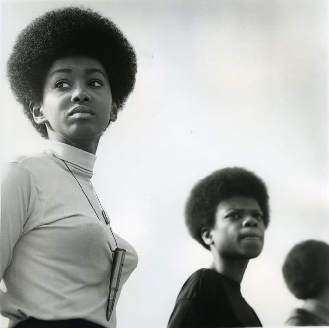 Close-up of two young women standing in line formation