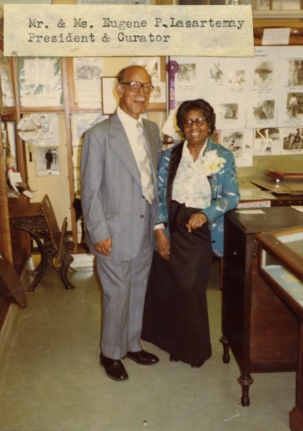 Eugene and Ruth Lasartemay standing next to exhibit case