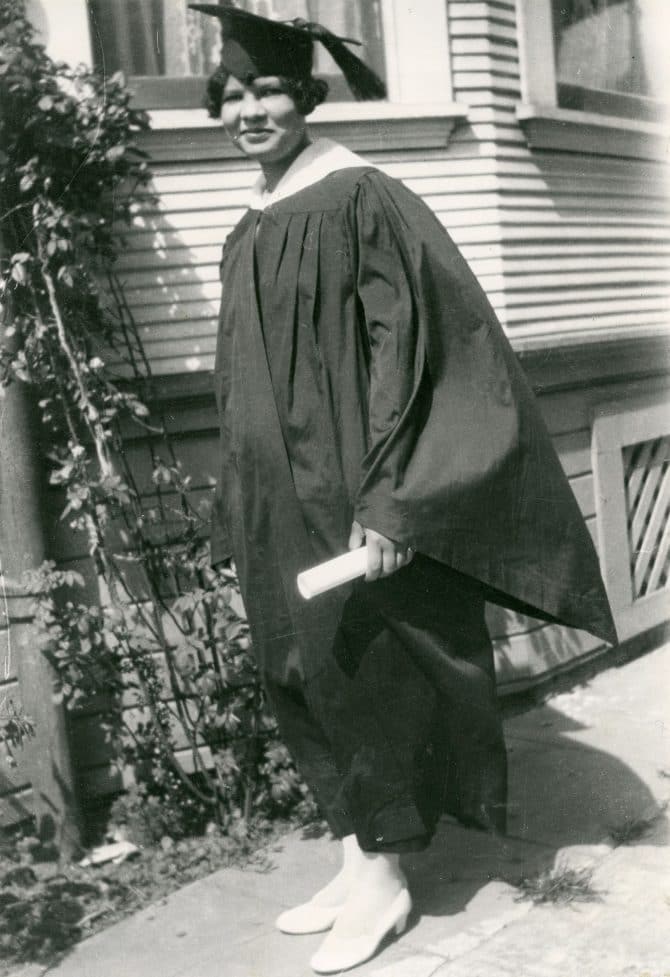 Miriam Matthews posing in graduation cap and gown