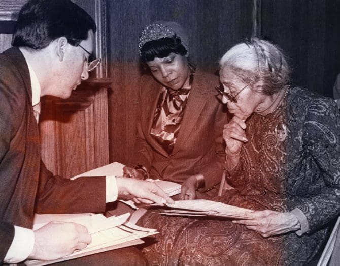 Rosa Parks examines family genealogical records at the Family History Library in Salt Lake City, Utah, with assistant Elaine Steele and library genealogist Jay Roberts