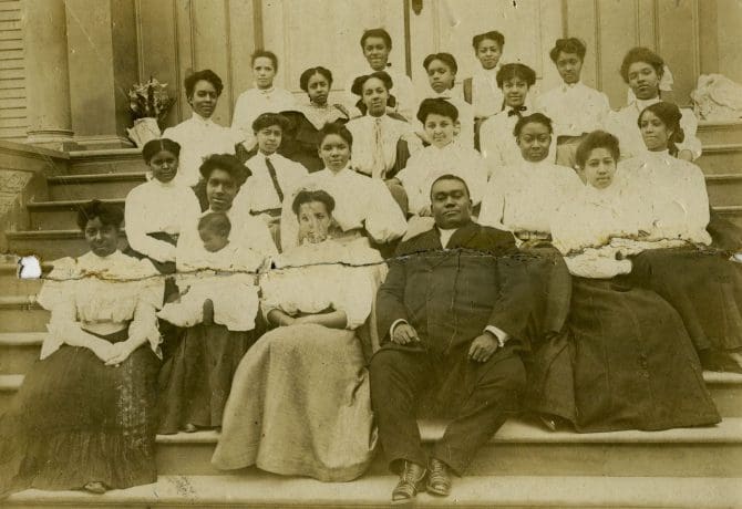 Members of First A.M.E. Church (Oakland, Calif.) choir seated on front steps of church