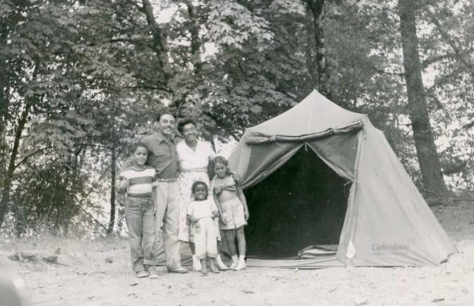 Mitchell family standing next to camping tent