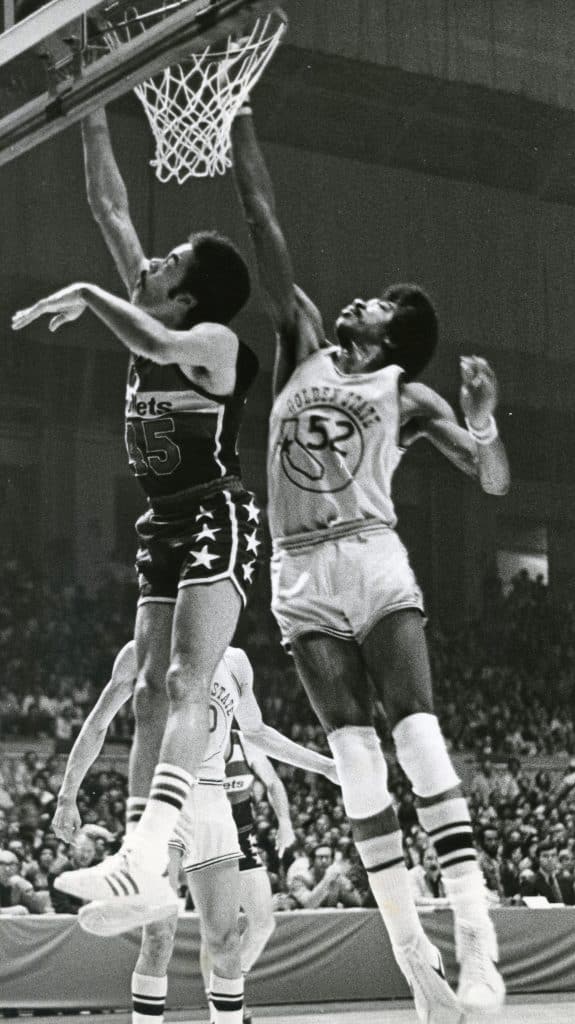 Golden State Warriors' George Johnson tries to block shot of Washington Bullets' Phil Chenier, circa 1970s