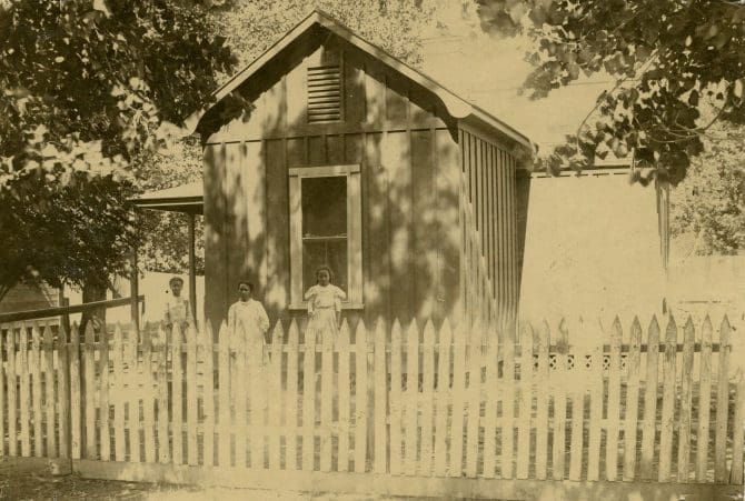 Three children standing in front of the William Henry Pickney house, Kern County, California