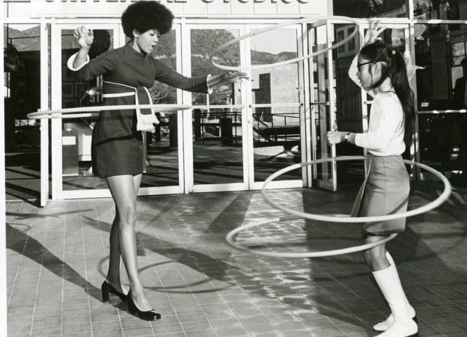 Olympic athlete Wilma Rudolph hula hooping with grand champion Melody Howe 1970-04-09