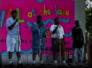 Image from a video of the Festival at the Lake's 1992 Young Artists Stage, showing four teenagers singing.