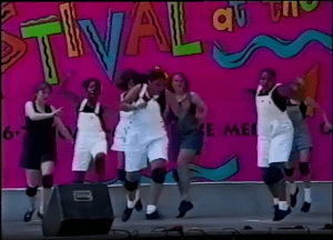 Image from a video of the Festival at the Lake's 1992 Young Artists Stage showing teenage dancers wearing denim overall shorts.