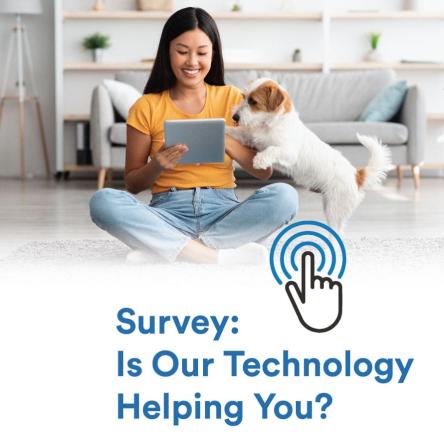 Young woman sitting on the floor with her dog looking at a digital tablet. Survey: Is Our Technology Helping You?