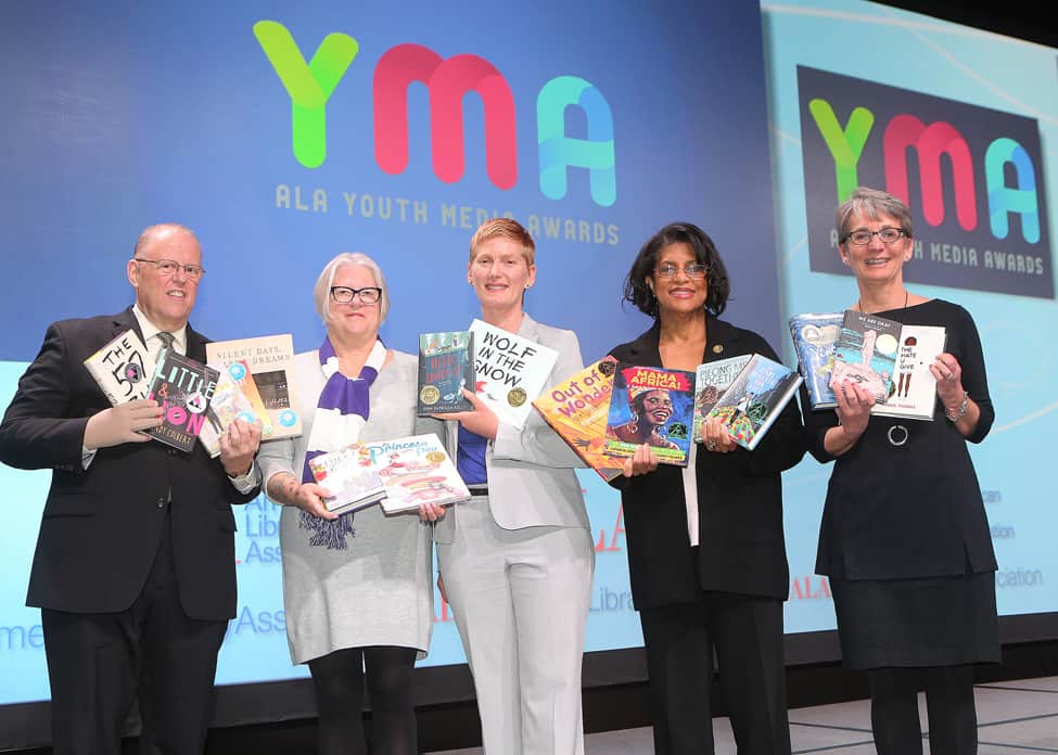 winners at the YMA pose with their books