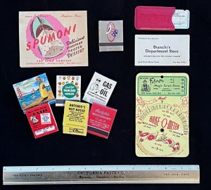 Assorted ephemera against a black background, corresponding to the businesses described.