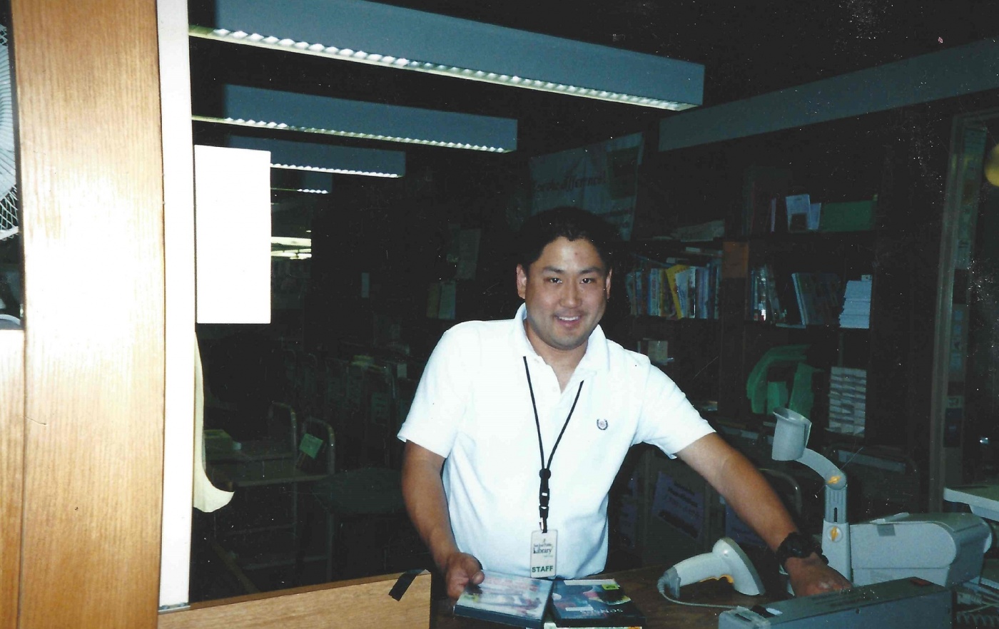 Scott Kimizuka started in 1981 at SJPL as a Page. Old picture of Scott doing materials handling