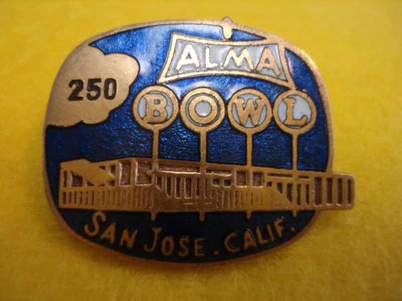 Image: A vintage pinback showing the exterior of the old Alma Bowl.