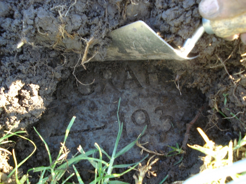Image: Finally locating Jack Graham's marker under a thick layer of sod.