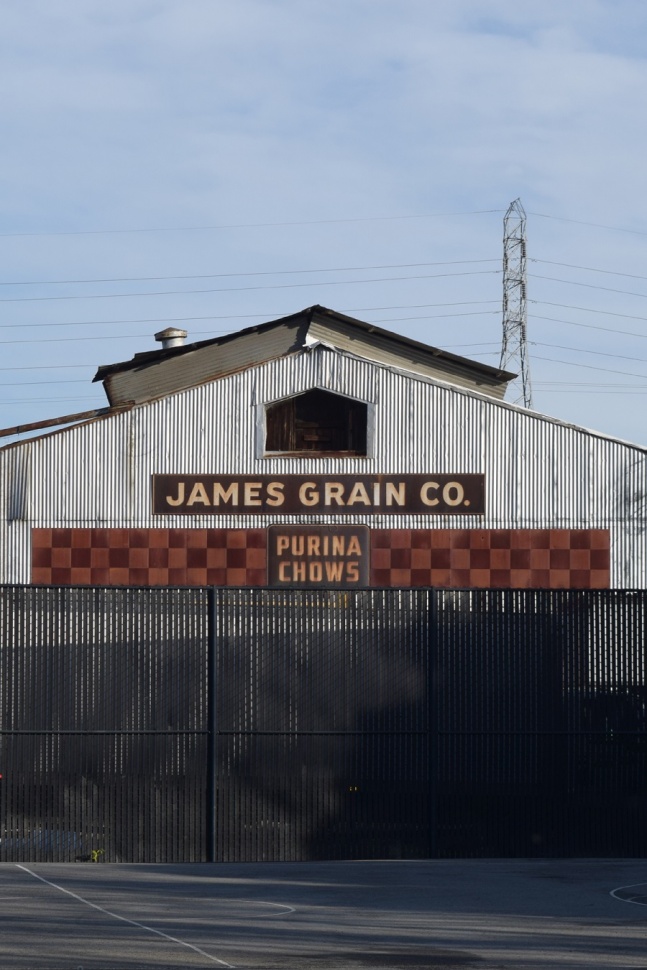 Image: Signage on the back of the James Grain warehouse. Photo ©Ralph M. Pearce.