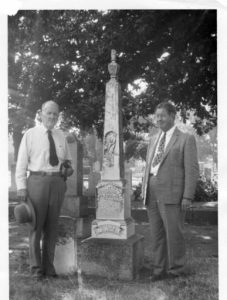 Clyde (left) poses with Colonel Waddell F. Smith at the gravesite of Montgomery Maze in Oak Hill Memorial Park.