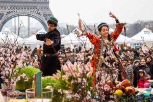 dancers and crowd celebrating Nowruz before the Eiffel Tower