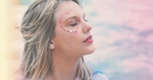 Taylor Swift with a glitter heart around her eye on a rainbow cloud background
