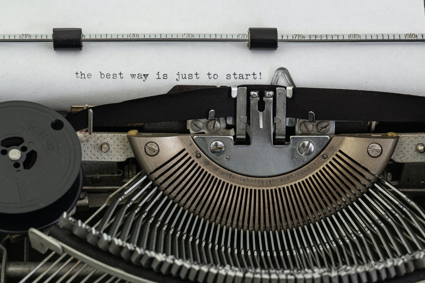 "The best way is just to start!" written on a typewriter.