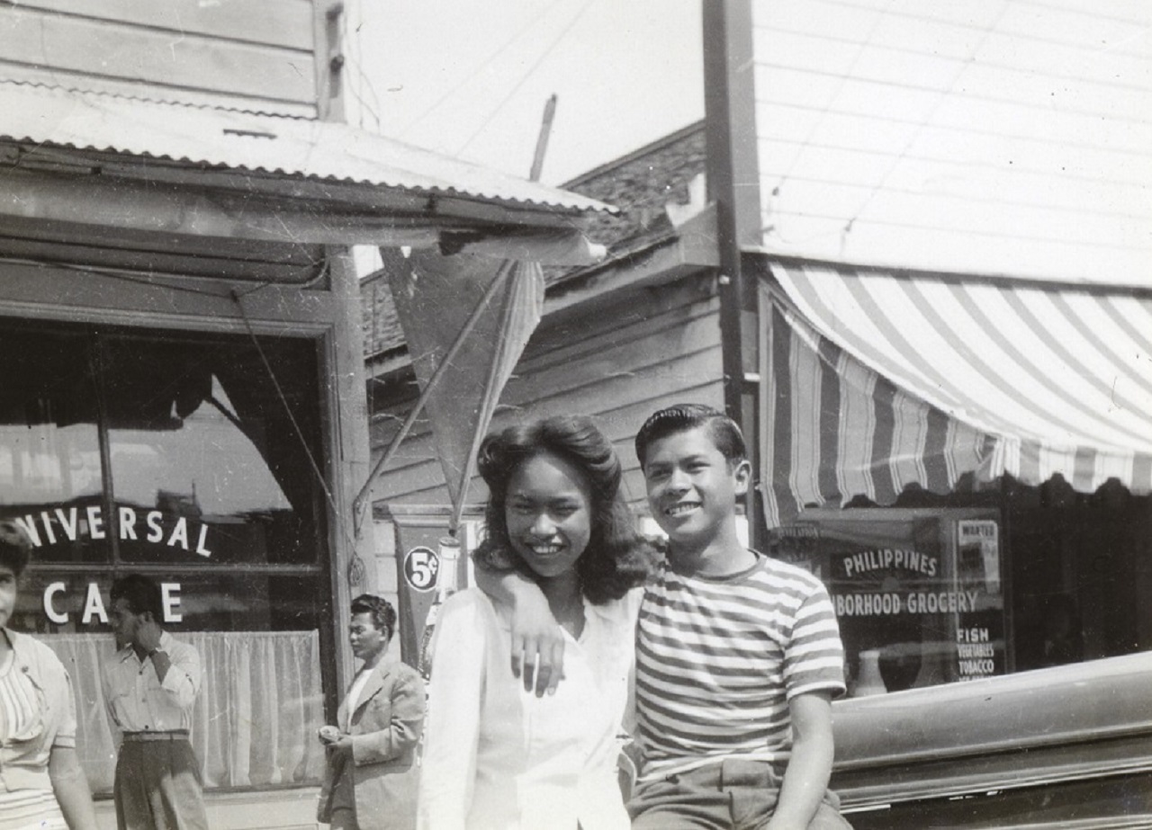 Image: Dorothy Quibelan and Fred Bacosa outside the Universal Café in San Jose's Pinoytown c.1943. Dorothy and Fred belonged to the U.S. born second or "Bridge" generation, Photo courtesy of Elaine Quibelan