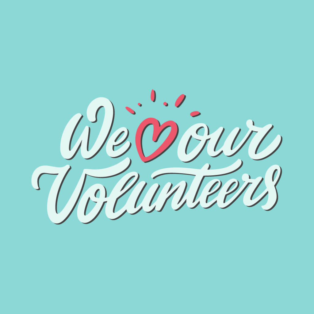 Pink heart. Cursive Text: We heart our volunteers.