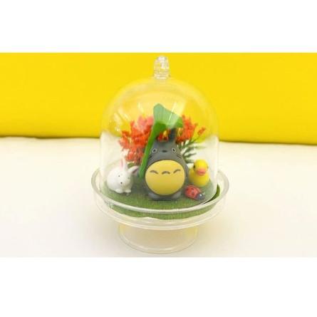 Mini terrarium featuring plants and anime figurines.