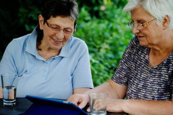 senior-ladies-sitting-in-the-garden-surfing-the-internet-on-their-tablet-this-file-has-two-releases_t20_zLNrZa