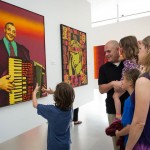 Patrons look at images in art gallery