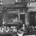 tables with piles of shoes in front of hardware store