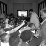 The students of Holy Angels School thank Mayor Harold Washington with a green lei for attending their 1987 St. Patrick's Day rally. Source: Harold Washington Archives and Collections: Press Office Photographs, Box 60, Folder 5. Photographer: Antonio Dickey