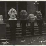 Four people wear grotesque heads. Source: Special Collections, Chicago Park District Records: Photographs, Image 043_005_006