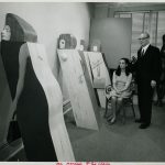Marisol Escobar sits and Edward H Weiss stands; both look toward Women Leaning.