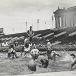 Athletes play water polo in the specially constructed swimming pool at Soldier Field for the Special Olympics, undated. [Anne Burke] looks on. Source: Chicago Park District Records: Photographs, Special Collections, Image 125_005_013.