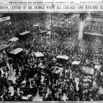 crowd of people, horses, cars filling intersection