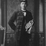 man in uniform holding brass instrument