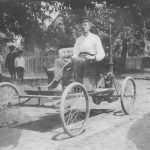 Man driving early-model car