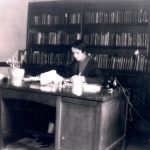 Vivian G. Harsh seated at her desk with the Special Negro Collection pictured behind her, early 1930s. Source: George Cleveland Hall Branch Archives, photo 019